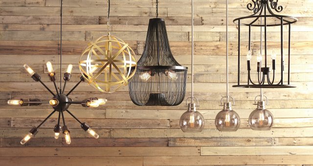 group shot of pendant lights hanging in front of rustic wood paneling.