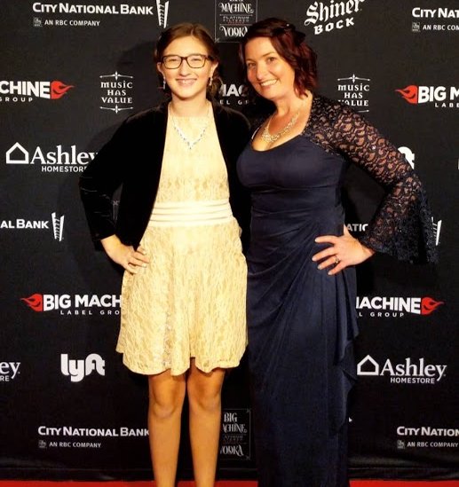 teenager and mother on red carpet